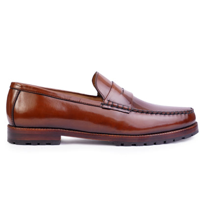 Side view of Brown colour Round toe Penny loafer formal shoes in leather with Blake stitched leather sole
